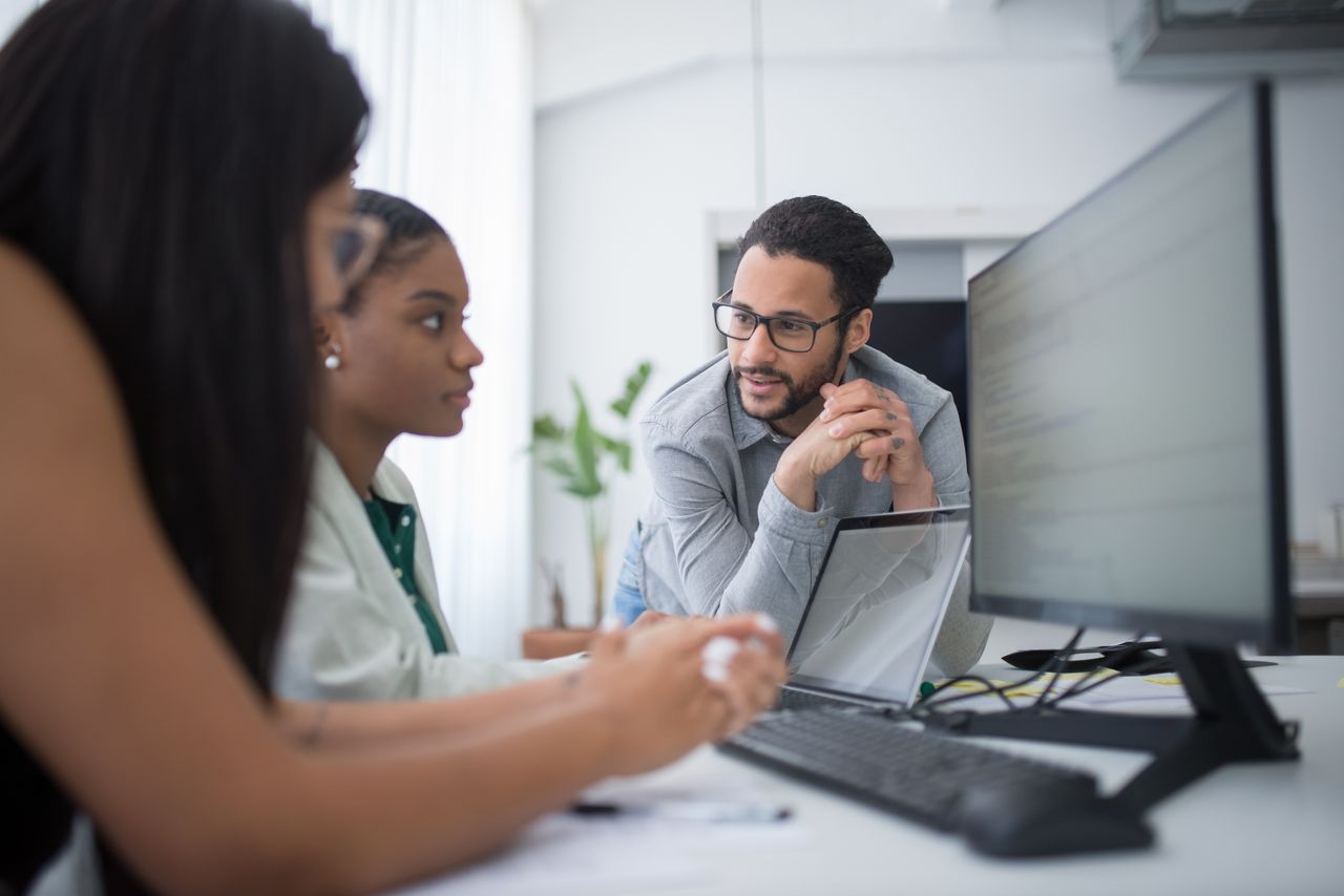 Services Diverse team engaging in collaborative work in a contemporary office environment.